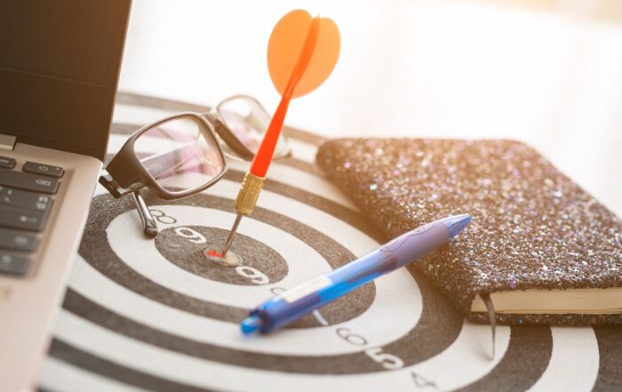 Team analyzing digital marketing strategy on laptop and charts – PCW Agency 2025.